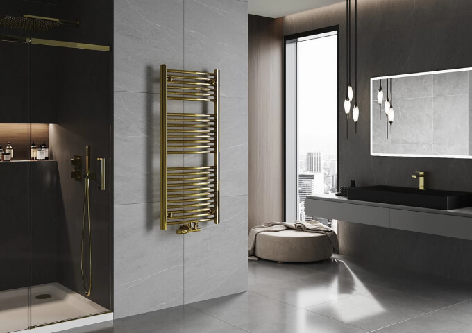 Golden radiator with thermostatic head in the bathroom