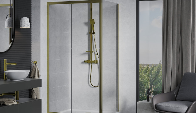 Golden fittings in a concrete bathroom