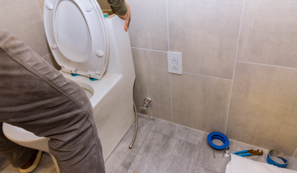 At what height should a wall-mounted toilet frame be installed?
