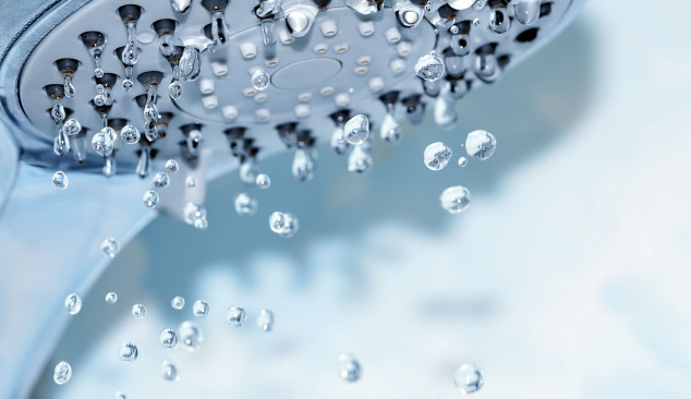 How does a shower head affect water conservation?