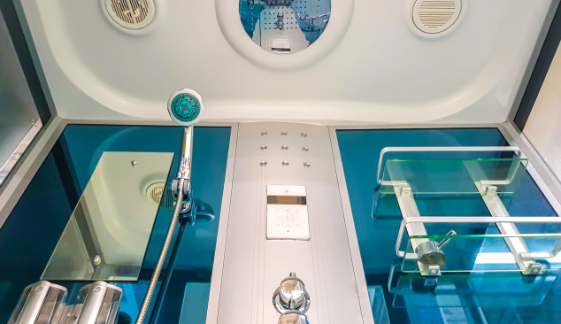 How should a shower cabin be cleaned?