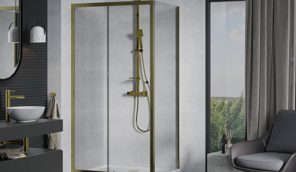Golden Fixtures in a Concrete Bathroom