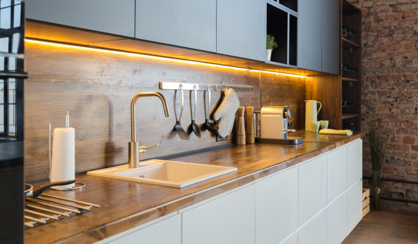 What instead of tiles in the kitchen on the wall above the sink?