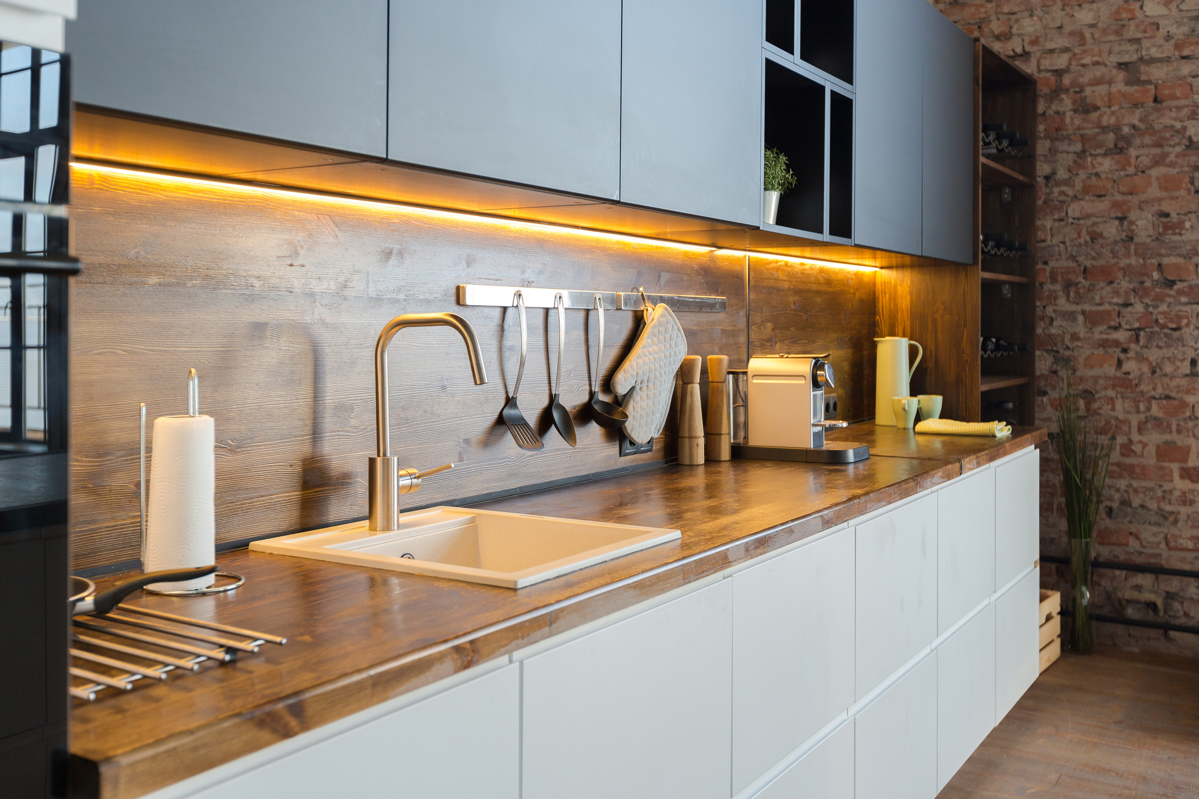 What instead of tiles in the kitchen on the wall above the sink?