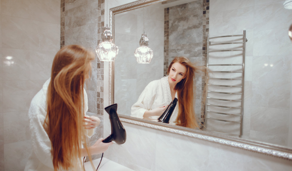 At what height should a mirror be placed above the sink for optimal results?