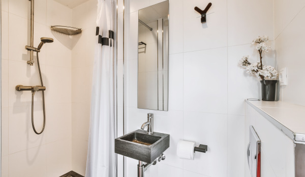 At what height should a sliding shower set be installed?