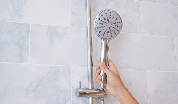 At what height should you install the shower head?